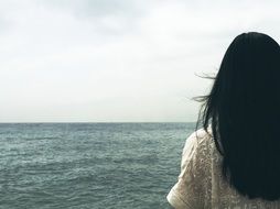 Photo of woman looking at ocean