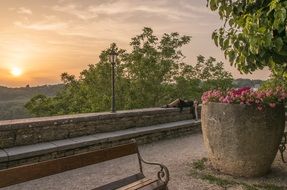 person lying wall bank park sunset view