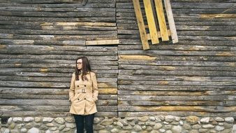 girl on the background of an old wooden building