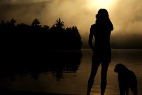 girl and dog staring into the distance