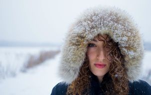 woman standing in the cold in the hood