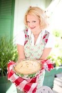 smiling woman holding apple pie
