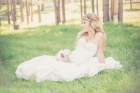 beautiful bride with bouquet on a meadow