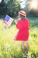 Girl holding fourth of july american flag