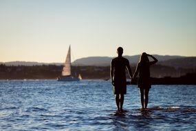 happy couple standing in the water