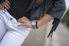 girl in leather jacket and white trousers