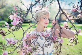 beautiful blond woman in magnolias flowers