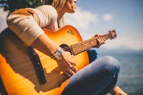 woman playing guitar