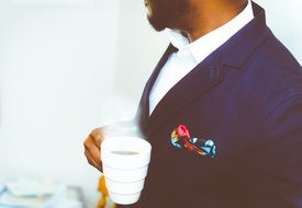 businessman with a cup of coffee in his hands