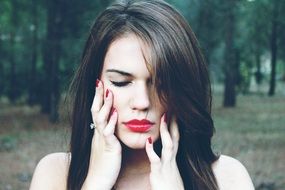 brunette with manicure and scarlet lips