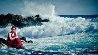 girl sitting by the ocean