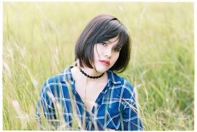 portrait of young woman in a grass