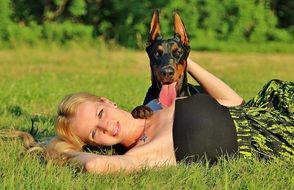 woman and dog on the grass