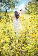 pretty long haired woman in white dress wildflowers summer