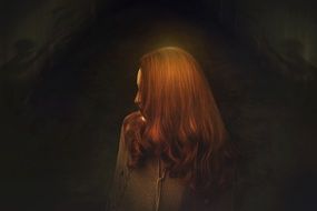 woman with red hair in the dark