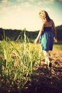 girl is walking on a meadow