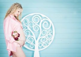 pregnant woman posing at blue wall