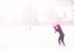 the photographer takes pictures of snow-covered trees in winter