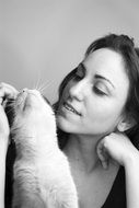 black and white photo of a girl with a kitten