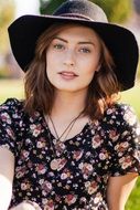 portrait of a beautiful girl in a black hat