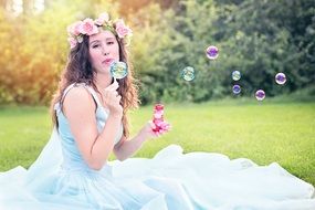 woman blowing bubbles