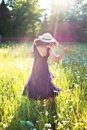 pretty woman dancing in sunny green field