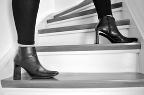 female legs in boots on the stairs