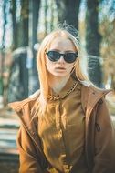 stylish blonde woman in sunglasses