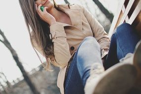 girl in jeans with a mobile phone