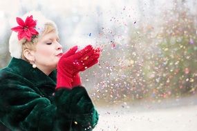 woman blowing glitter outdoor