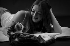 lying young woman cat black white photo