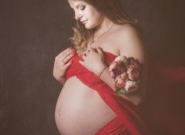 pregnant woman with flowers at a photo shoot