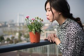 very beautiful woman and potted flowers