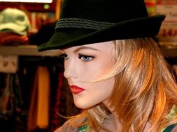 mannequin of woman in hat with blond hair