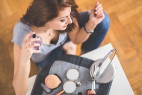 woman spraying perfume