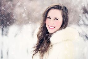 Portrait of woman smiling in a snowy forest