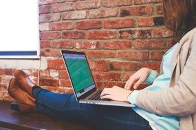 female student typing on laptop