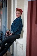 girl in 1950s style near the wall