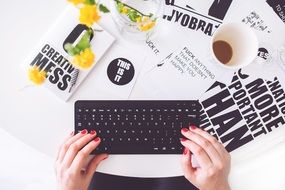 mess in the workplace, keyboard and coffee in a glass