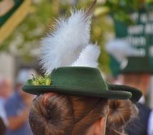 girl with a green hat with a feather