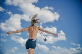 girl young woman back slim sky clouds
