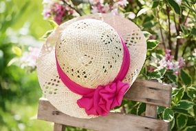 straw hat with a pink ribbon