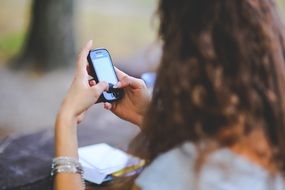 cell phone in womans hands