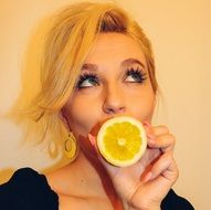 young girl with an orange in hands