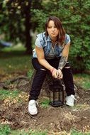 girl sitting on a tree stump