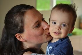 mother kissing child