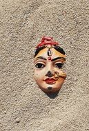 indian woman statue face in sand