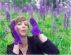 woman posing in front of purple flowers filed