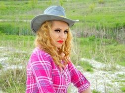 blonde woman in cowboy hat portrait