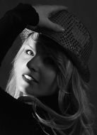 black and white photo of a girl in a hat